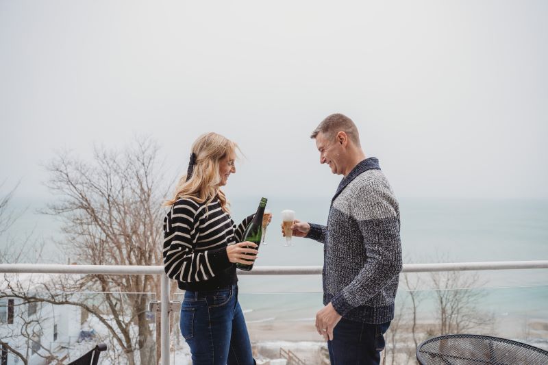 A couple toasting on a romantic getaway in Michigan