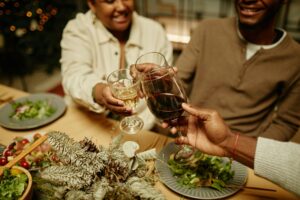 Holiday Vacation Rentals: a family says cheers while enjoying a holiday dinner in their vacation rental.