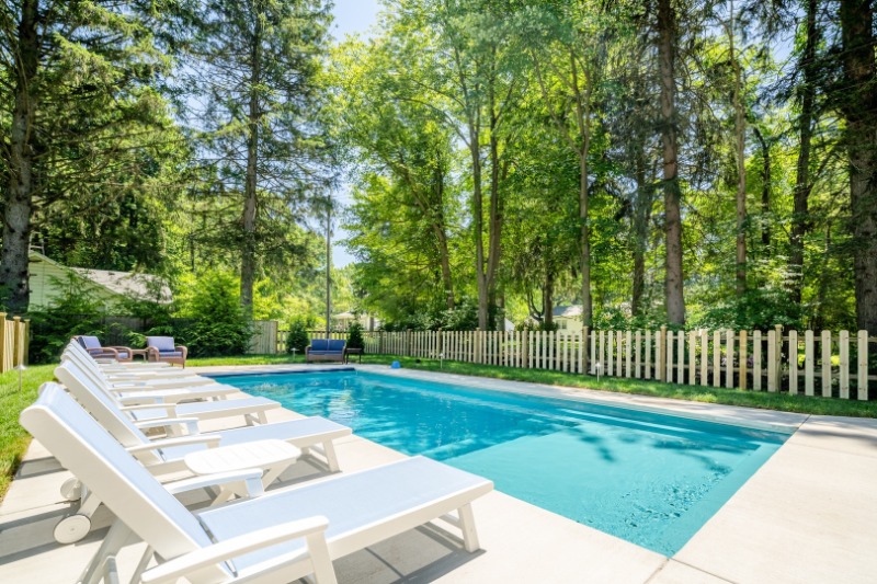 A poolside view of the backyard at Wheel Tree Cottage.