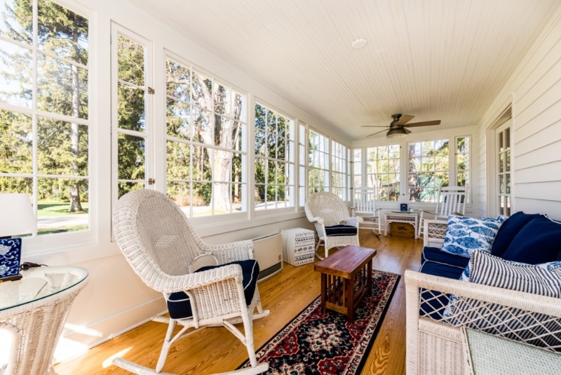 An inviting sunroom at Blue Canary Cottage vacation rental in Lakeside, MI.